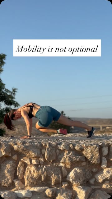 Mari practising a floor-based mobility movement outdoors.