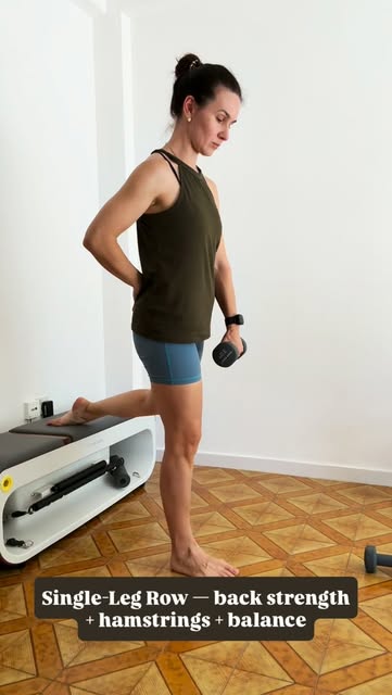 Mari holding a dumbbell with one foot supported on a bench.